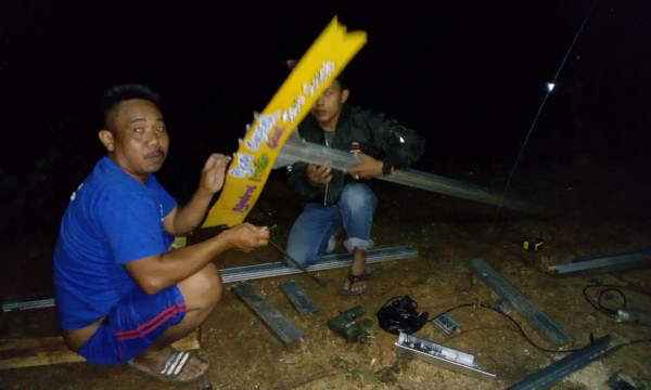 Ketua BKR sedang memasangkan slogan pakai tiang dari Baja Ringan